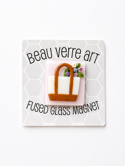 Shop the Beau Verre Tote with Flowers Needleminder — charming handcrafted glass art with strong magnetic hold. A beautiful gift for needlepoint enthusiasts.