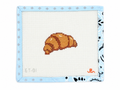 Croissant needlepoint canvas by Good Point on 13 mesh with a 2" x 3.3" design area. Canvas only; threads not included.