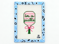 Stitch the playful In a Pickle pickleball racket needlepoint canvas by Ivy Thread. The design measures 4.4 x 2.25 inches; threads are not included.
