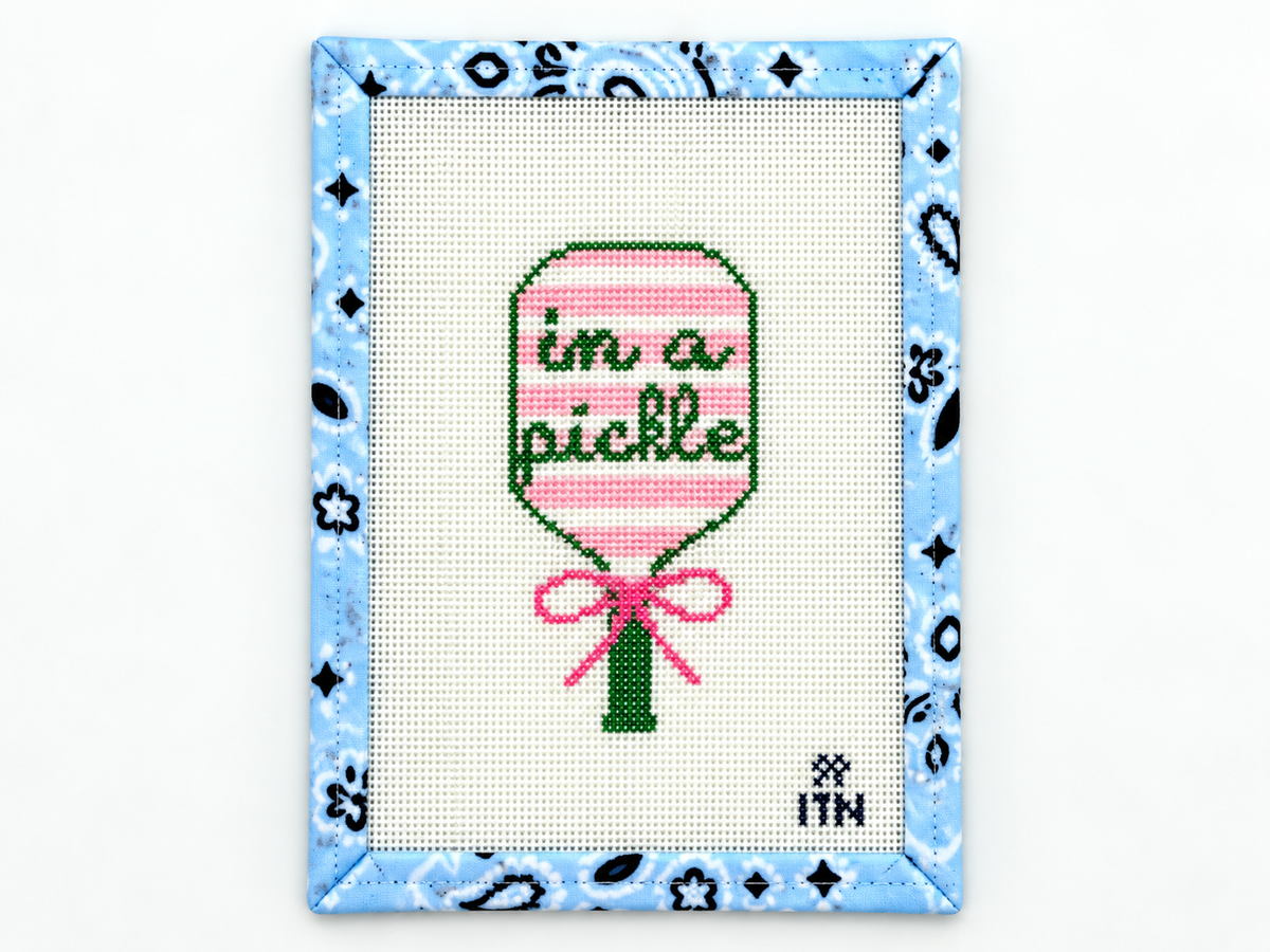 Stitch the playful In a Pickle pickleball racket needlepoint canvas by Ivy Thread. The design measures 4.4 x 2.25 inches; threads are not included.