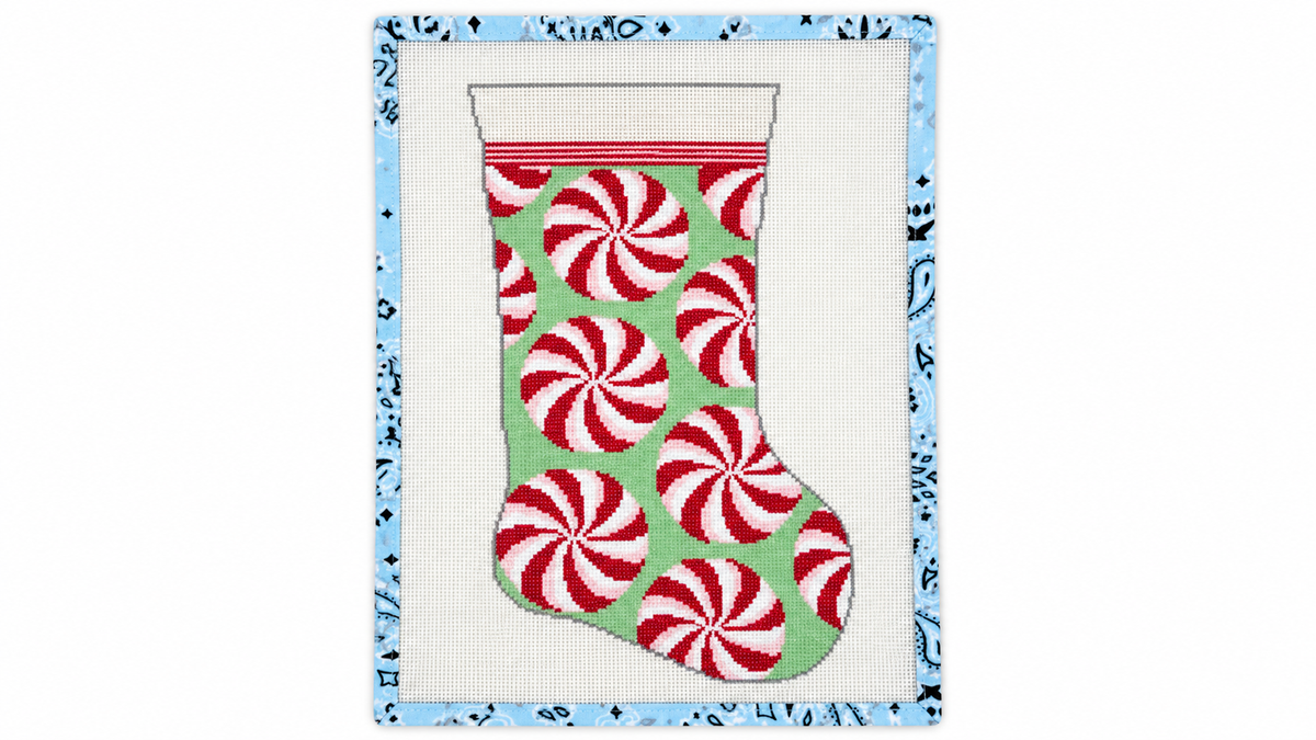 Stitch a festive red and mint peppermint stocking with this SCT Designs needlepoint canvas. 11” x 19” on 13 mesh. Threads not included.