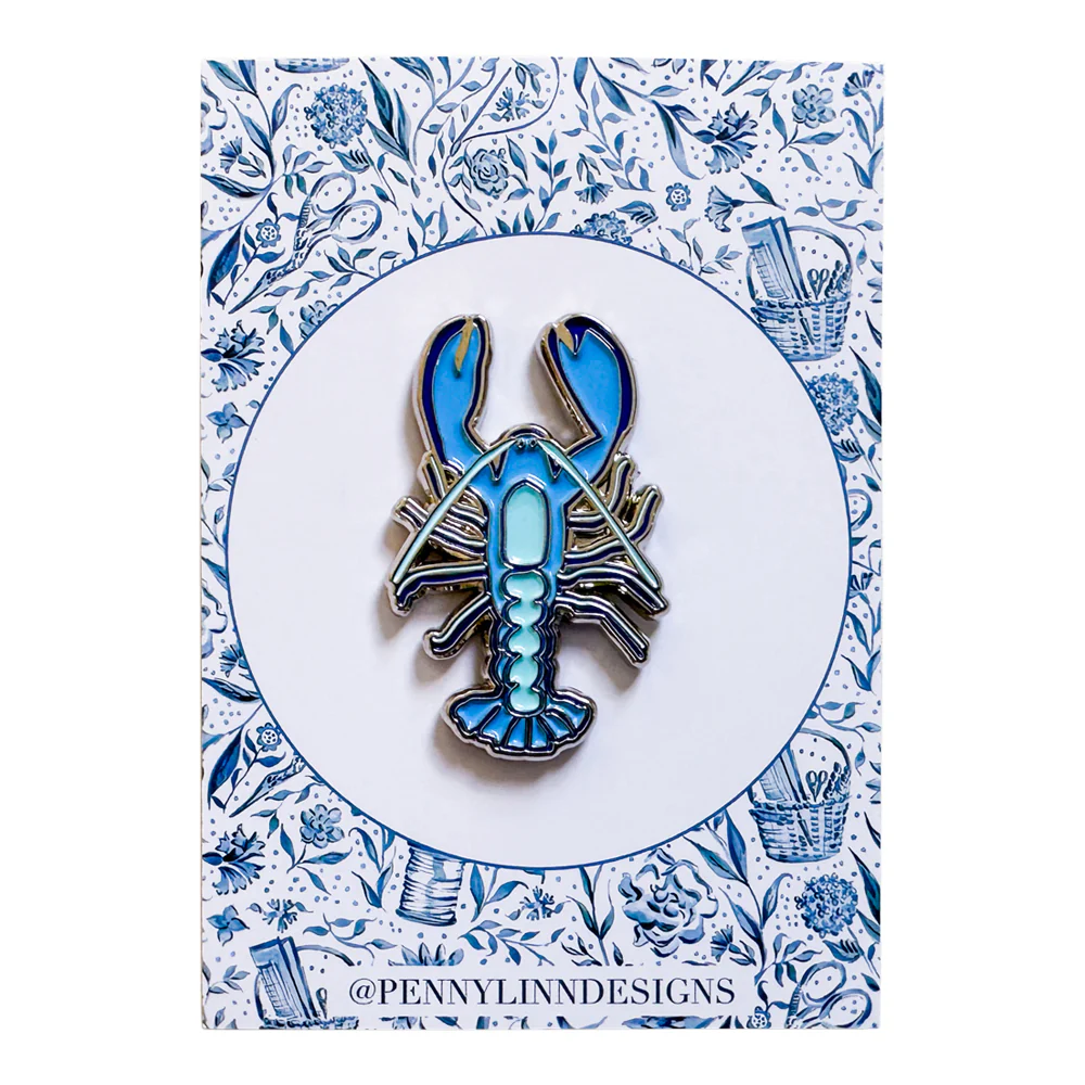 Blue and silver lobster pin on a floral patterned card with 'Penny Lin Designs' branding.