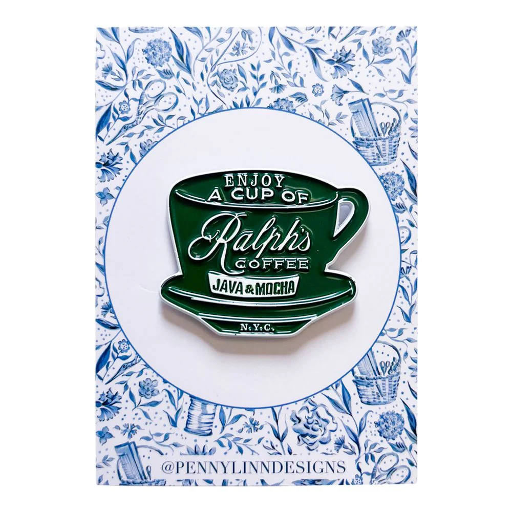 Enamel pin of a green coffee cup with text on a decorative card