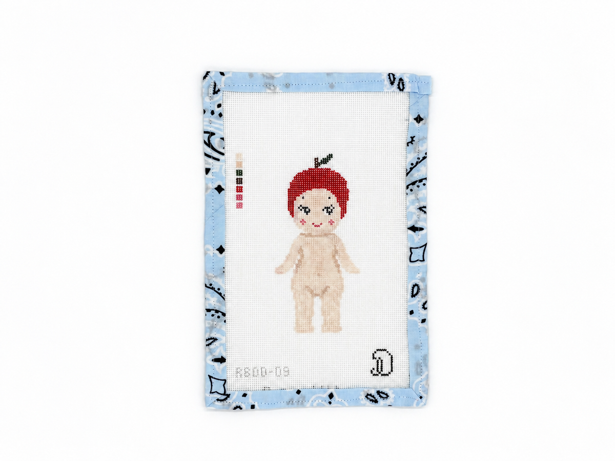 Apple Sonny Angel needlepoint canvas by Dana Jean Designs, stitch painted on 18 mesh. Design: 2 x 4.8 inches. Threads not included.