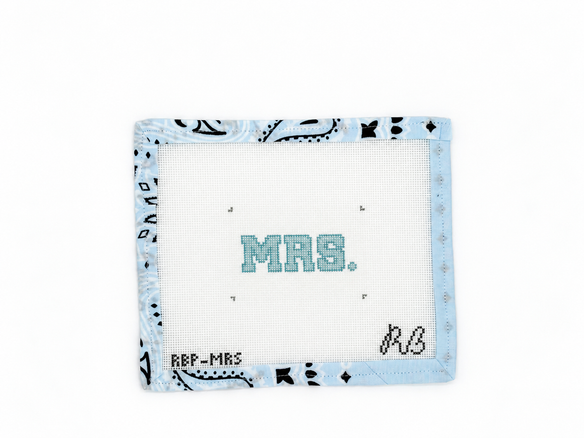 Stitch Rachel Barri’s MRS. needlepoint canvas on 18-count mesh for a bag charm or luggage tag. Canvas comes unstitched; threads not included.
